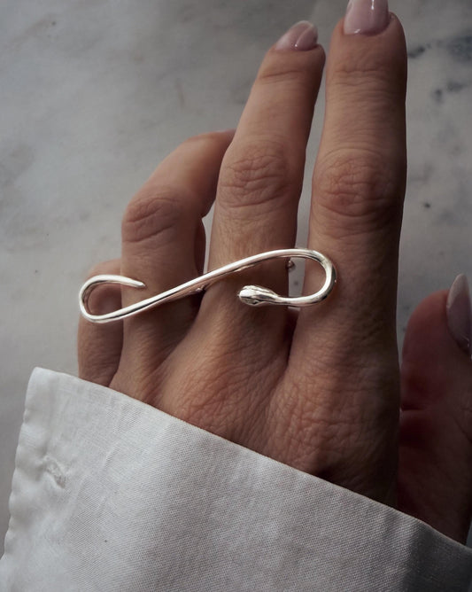 A Sterling silver 925  ring with a snake design. The ring curves over two fingers, creating an elegant and modern look.